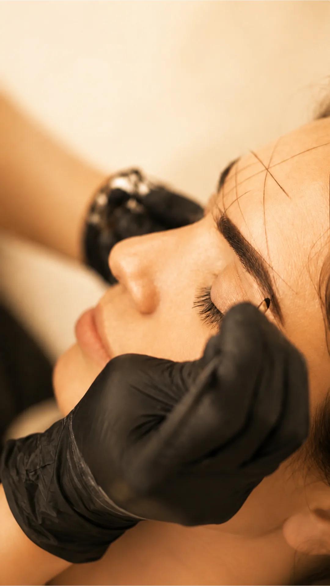 A brow artist mapping and shaping brows