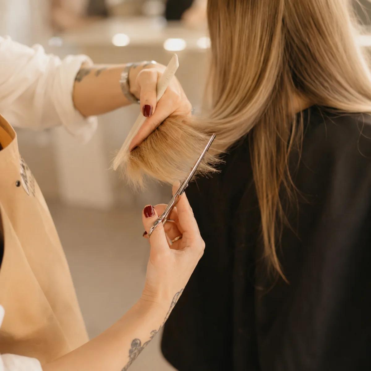A precise haircut on long blonde hair